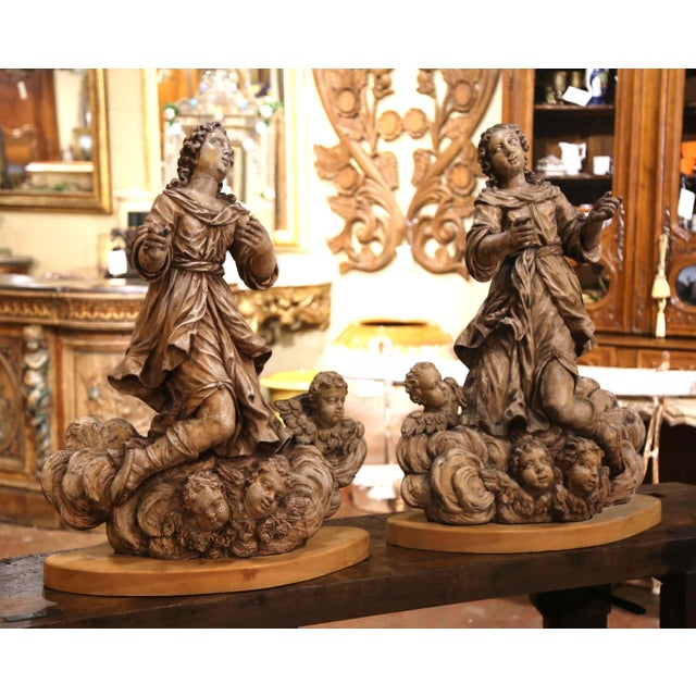 Full of movement and devotional expression, this impressive pair of antique religious sculptures depicts two adoring...