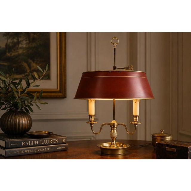 A quintessentially french bouillotte table lamp of exceptional character and presence — warm polished brass, a two-light...