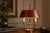 A quintessentially french bouillotte table lamp of exceptional character and presence — warm polished brass, a two-light...