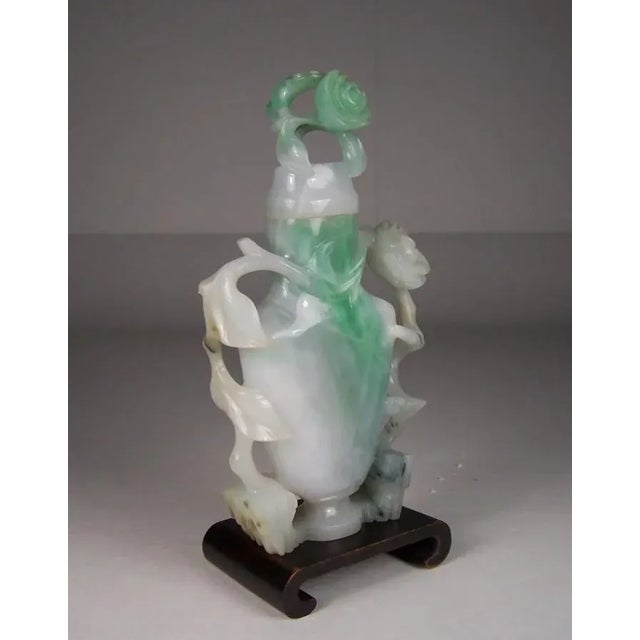 Rare table size white jadeite Chinese snuff bottle with apple green and emerald green markings along with some blushes of...