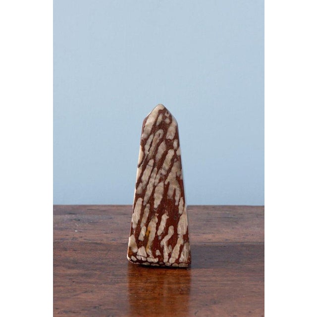A rare midcentury obelisk in rouge griotte marble, with a distinctive short, wide form, sharply defined edges, and a...
