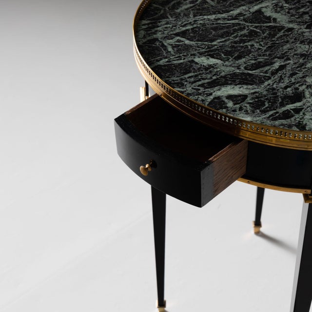 Elegant ebonized side table featuring a brass gallery and a convenient small drawer. Topped with a striking green marble,...