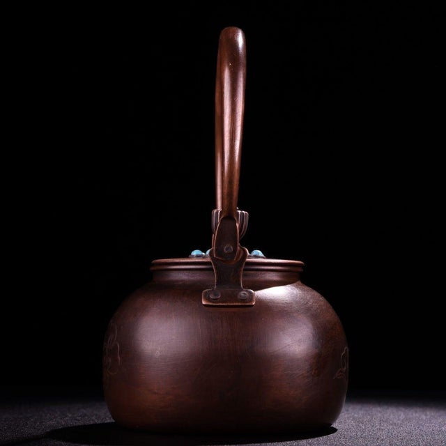 This elegant vintage teapot is a fine example of traditional metalwork, handcrafted from solid copper. The body features a...