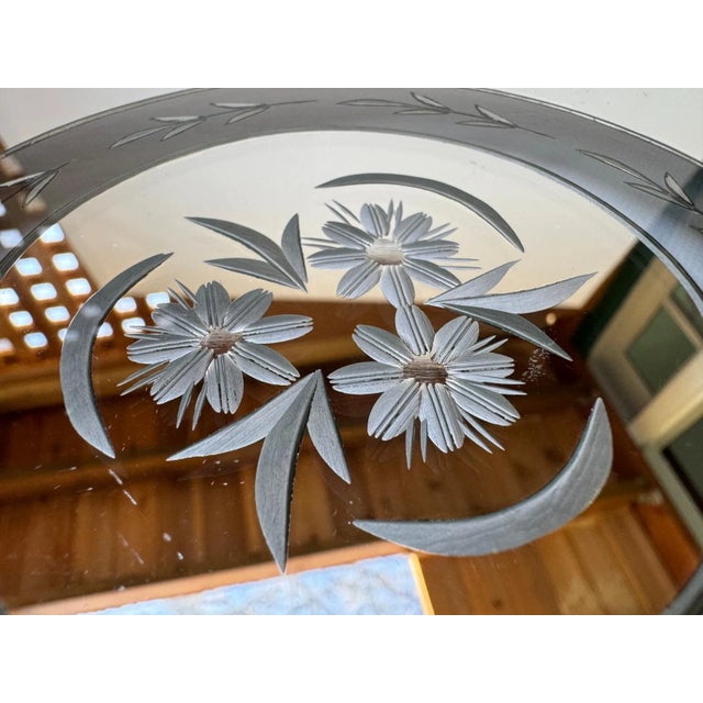 Vintage mirrored tray with an etched glass surface featuring a central floral medallion and fine linear border detailing....