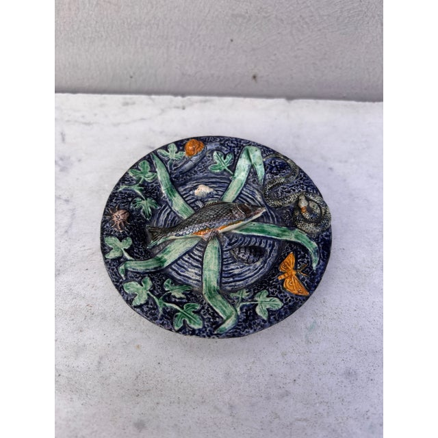 Small 19th Century round Palissy fish platter Thomas Sergent. decorated with a fish on the center ,on the border a snail,...