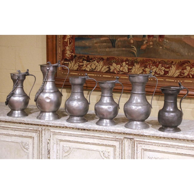 Decorate a bar, kitchen shelf, wine cellar or tabletop with this charming set of six antique French pewter wine measures,...