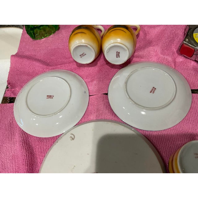 A striking collection of six vintage Japanese lusterware pieces dating approximately to the 1920s–1930s. The collection...