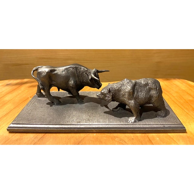 The famous symbols of Wall Street face off in this striking pewter bull and bear sculpture. Expertly cast with rich...
