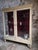 This vintage French display cabinet was originally used in a shop or commercial setting. The cabinet has a cream-painted...