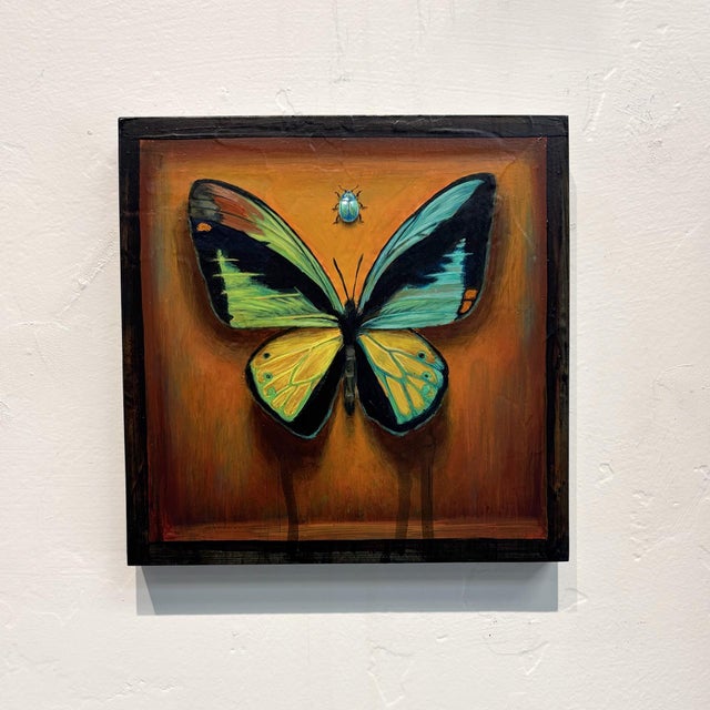 This artwork features a vibrant butterfly at its center, with striking turquoise and yellow wings set against a warm,...