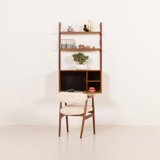 Wall-mounted teak shelving unit with a drop-front bureau , designed by poul cadovius for cado in the 1960s. This...