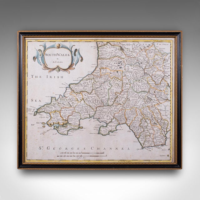This is an antique framed map of South Wales. An English, atlas engraving of cartographic interest By Robert Morden,...