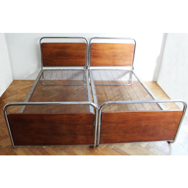Both beds are in good vintage condition. The steel frames and wooden panels display a gentle, authentic patina consistent...