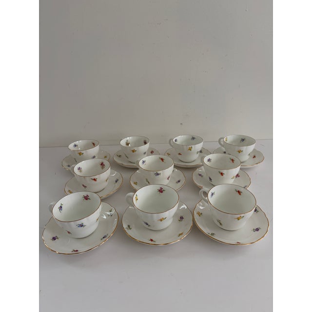 Vintage set of ten Benporslin demitasse cups with matching saucers, made in Sweden. Crafted of fine white porcelain, each...