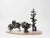 Set of 3 abstract solid bronze sculptures arranged on a thinly sliced petrified palm root slate. Organic shapes in the...