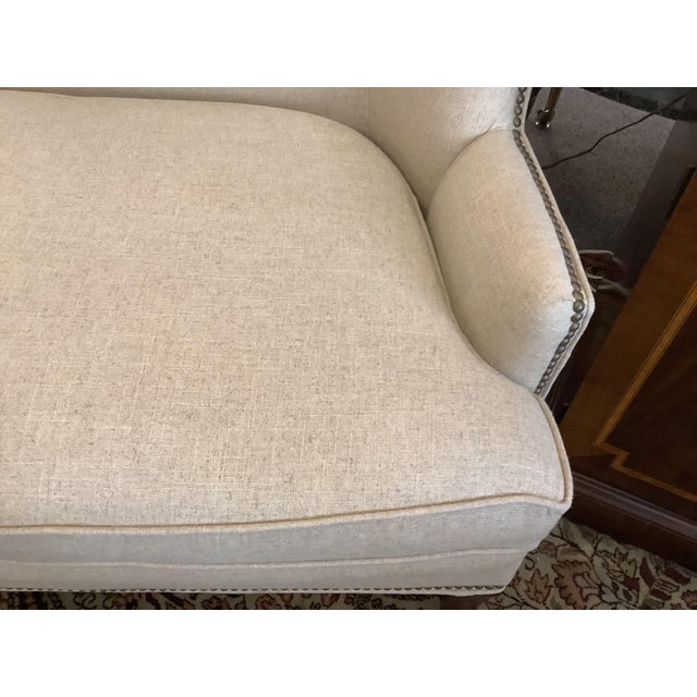 Lovely high back loveseat in wheat color with nailheads. Single bench seat cushion. This is a custom upholstered loveseat.
