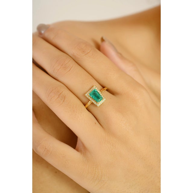 Celebrate milestones in timeless elegance with this striking 18k yellow gold ring. Featuring a 0.98-carat emerald-cut...