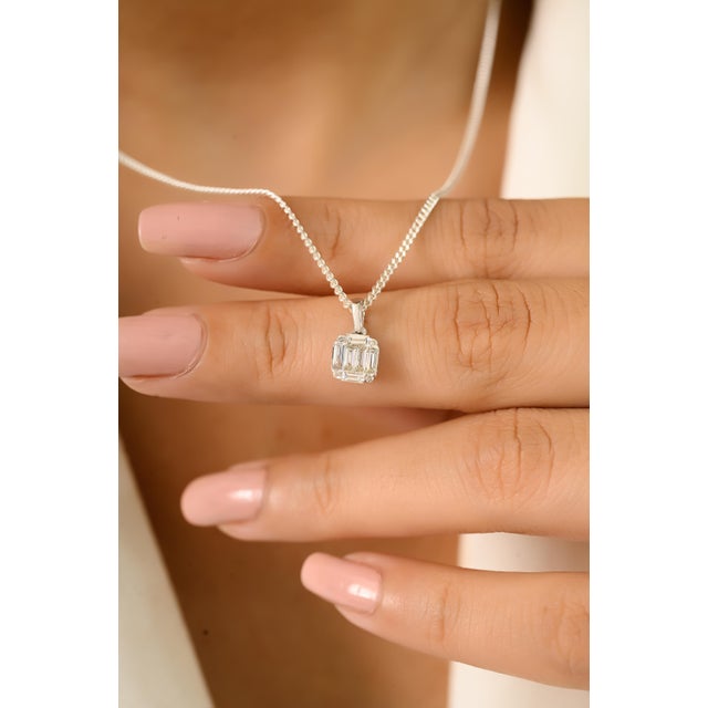 This elegant pendant features a stunning cluster of baguette and round-cut diamonds, totaling 0.26 carat beautifully set...