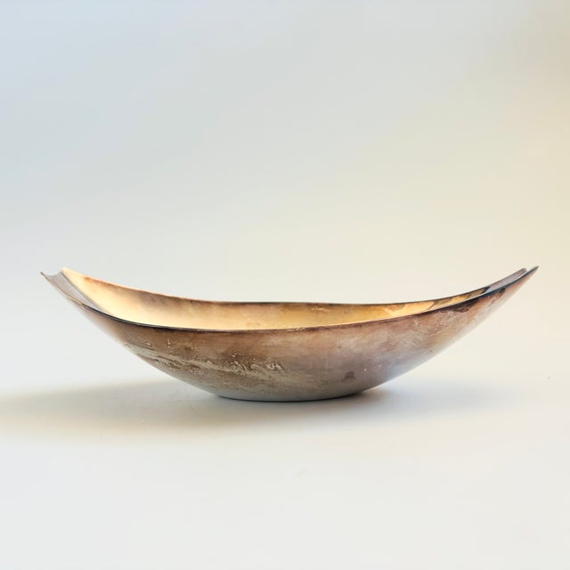A mid century silver plated oval canoe shaped bowl. Made by Reed and Barton, original label attached to the base. Measures...