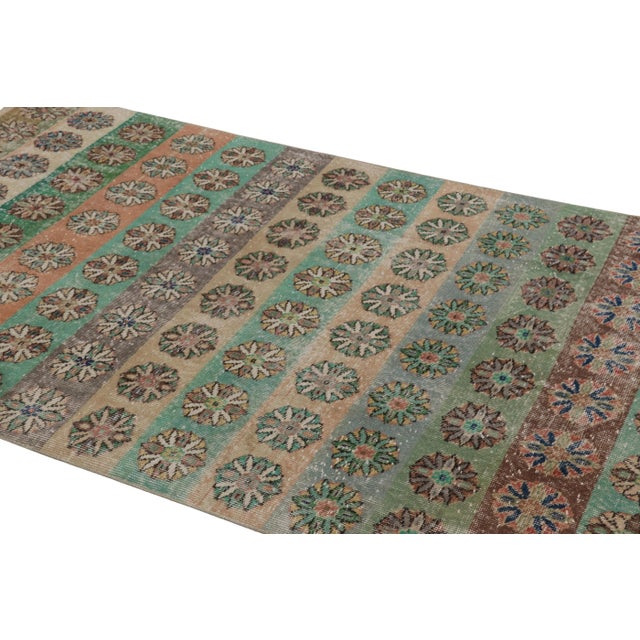 This vintage rug is a 5x9 Turkish distressed piece, made with hand-knotted wool circa mid-20th century. It is an exciting...