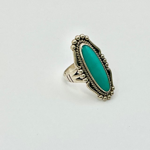 This is a lovely Southwestern Turquoise and Sterling Silver Ring. It features an elongated Turquoise gemstone set in...