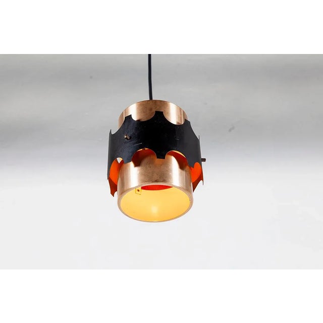 This Danish pendant light is made of copper and black lacquered metal. It was designed by Werner Schou and produced by...