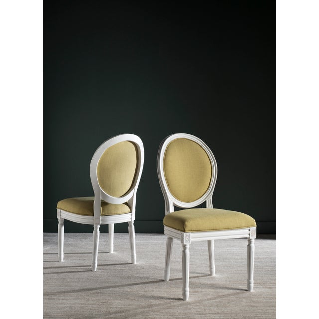 Brim With French country charm, this set of two dining chairs boasts a pretty cream frame, spring green linen upholstery...