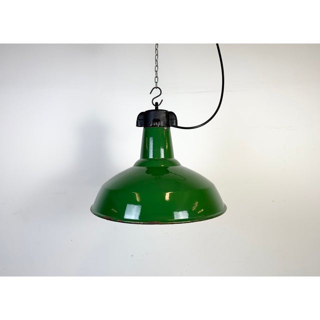 Industrial green enamel factory pendant light made in United Kingdom during the 1960s. White enamel inside the shade. Iron...