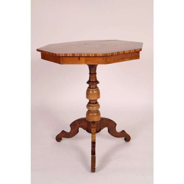 Italian inlaid octagonal shaped side table with extensive inlay, circa 1930's. With an octagonal top with exotic wood...
