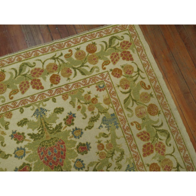 A room size Spanish rug. Ivory field, accents in green, blue, raspberry and orange. 8'4'' x 14'