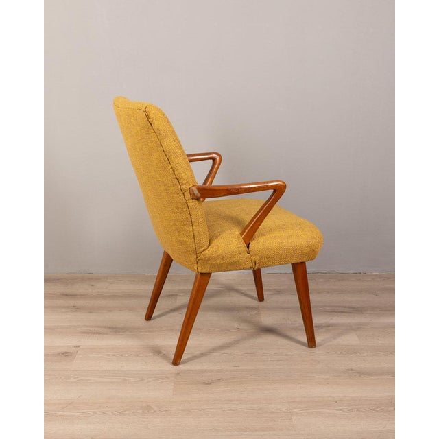 Armchair with wooden structure and yellow fabric covering, Italian design, 1960s.