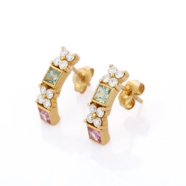 Earrings create a subtle beauty while showcasing the colors of the natural precious gemstones and illuminating diamonds...