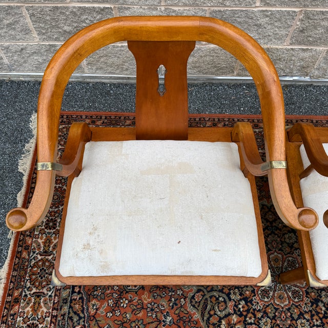 A pair of vintage Schnadig James Mont Ming style horseshoe chairs in maple with brass trim. American made. Circa late 20th...