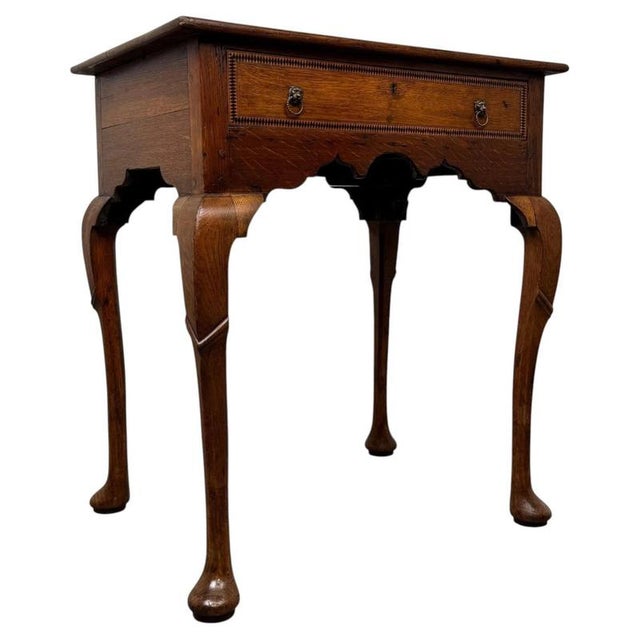 An exceptional and beautifully crafted 18th-century English Georgian side table, finely constructed in oak and...
