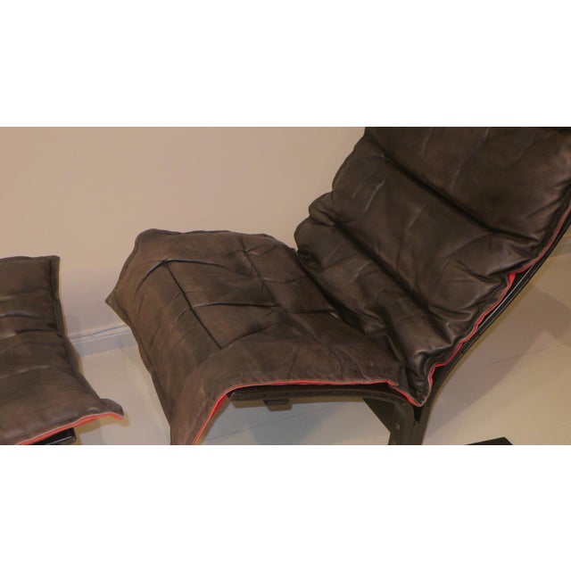 Westnofa lounge Chair with footrest, Norway 1960s. Throw-over covers in leather with a very attractive unusual red...