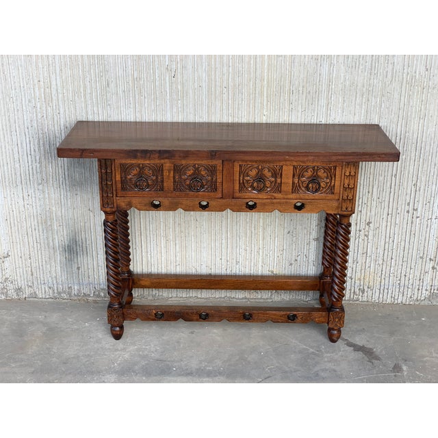 About This exquisitely carved mixed-wood two-drawer Baroque library table hails from the Provincial capital of Valladolid...