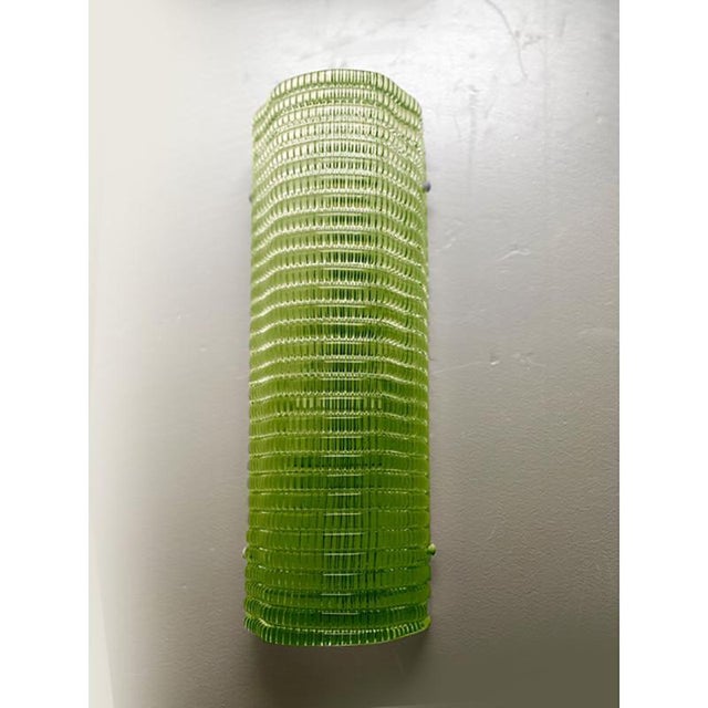 Set of two contemporary wall sconces made in murano glass with a modern diamanted texture that give it bright even if the...