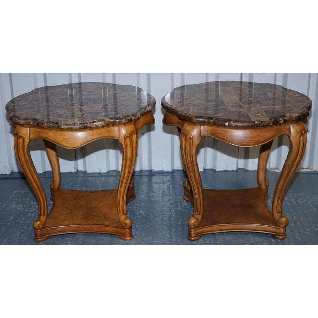 This elegant pair of vintage side tables is designed in a classic French style, featuring beautifully crafted faux marble...
