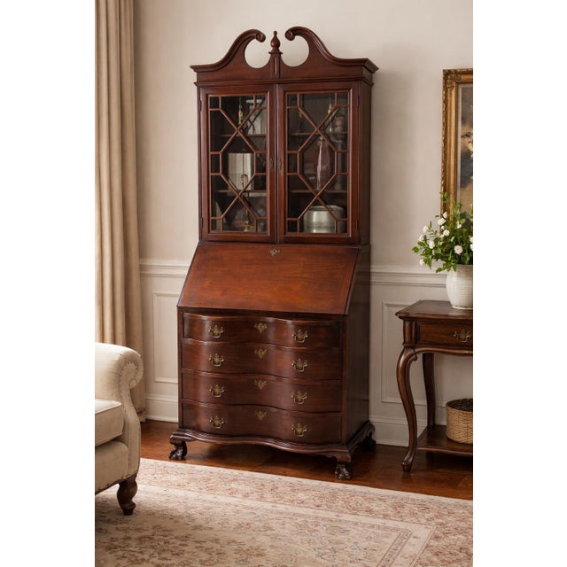 A refined 1930s–1940s American Colonial Revival secretary bookcase by Northwestern Furniture Co. of Burlington, Iowa....