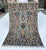 Persian Sarouk design hand-knotted rug featuring vertical columns of elegant turquoise palmette medallions and rust...