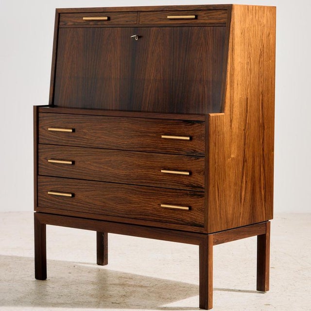 Danish rosewood bureau desk from the 1960s, designed by Gunnar Falsig. The desk has five drawers, a fold-down writing...