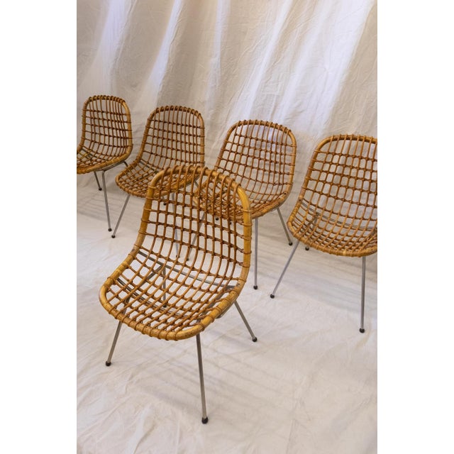 Designed by Gian Franco Legler in the 1960s, this set of six chairs combines an iron rod frame with a woven bamboo seat...