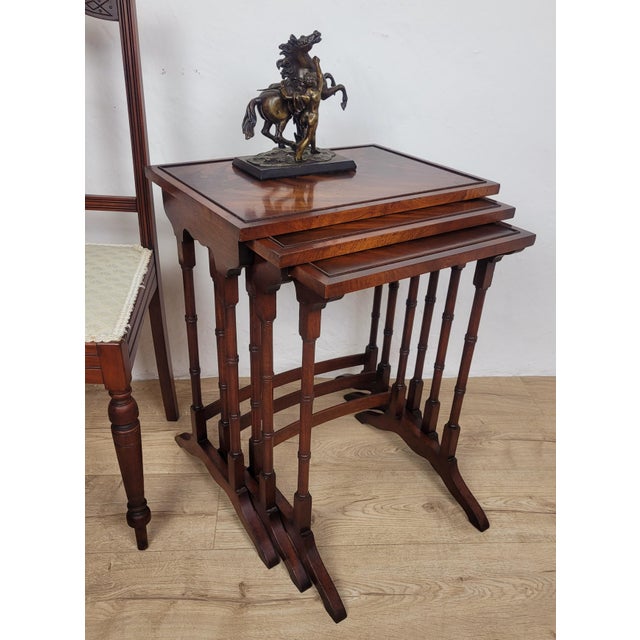 This nest of tables boasts wonderful antique features The tabletop display a rich, high quality mahogany patination that...