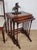 This nest of tables boasts wonderful antique features The tabletop display a rich, high quality mahogany patination that...