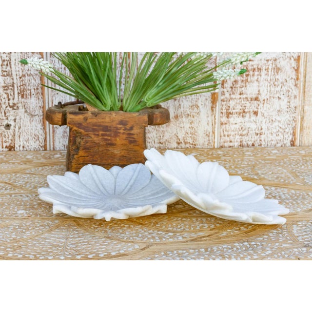 Beautiful small marble plate with carved open lotus flower motif and a warm polished finish. This Indian plate is the...
