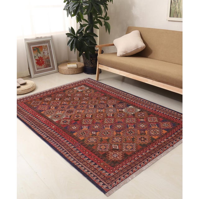 Experience the exceptional craftsmanship of this stunning Soumak rug, expertly created by skilled master weavers. Made...