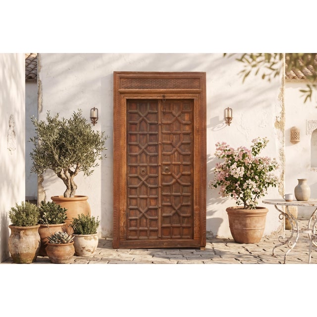Hand-carved from solid teak, this Antique Indian Architectural Door and Frame is a testament to the master woodcraft of...