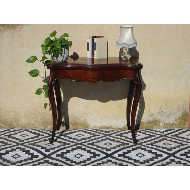 Console table that unfolds into a games table. Antique, late 19th-century craftsmanship in solid mahogany. rectangular top...
