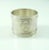 An elegant French silver napkin ring with cross ribbons over decorative bands. A large oval cartouche on the front is...