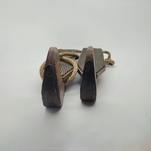 Antique wooden ice skates feature a classic primitive design with solid wood bases and metal runners. These decorative...